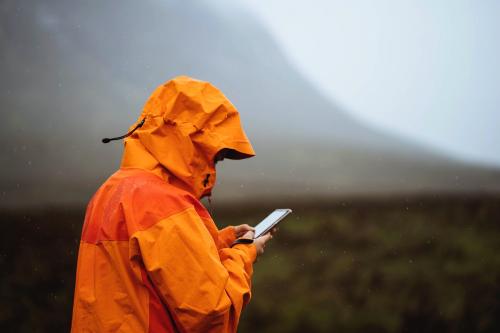 Woman using her mobile phone in the highlands - 1077924