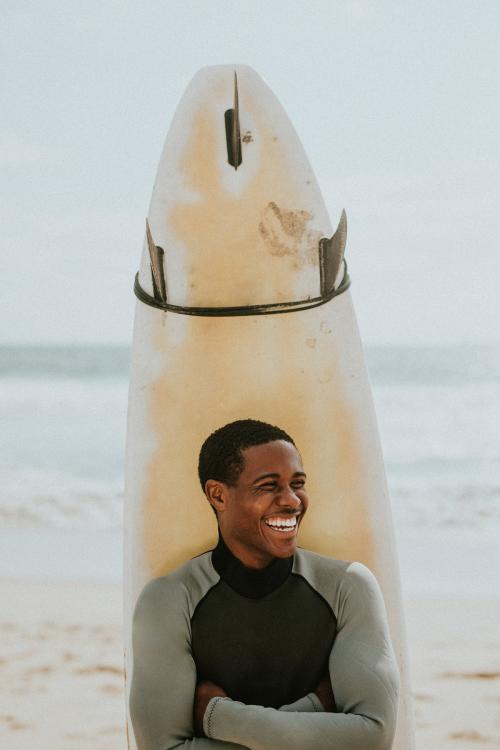 Cheerful man with a surfboard - 1079735