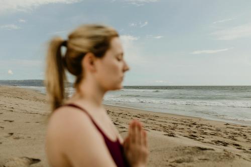 Woman practicing yoga on the beach - 1079811