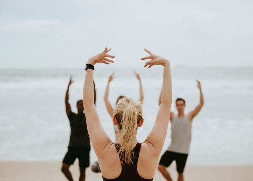 Athletic people stretching at the beach - 1079959