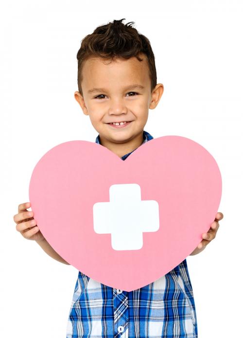 Little boy smiling and holding a medical care symbol - 7346