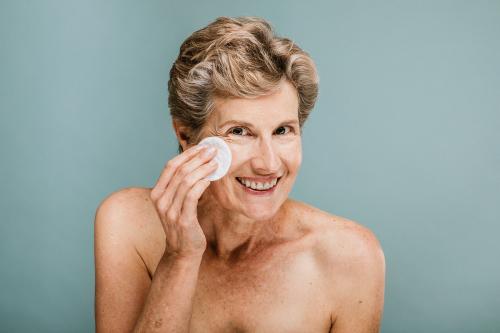 woman wiping her face with a cotton pad - 1203188