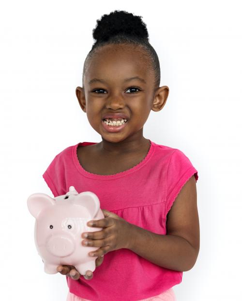 Cute little girl smiling awkwardly holding a piggy bank - 6815