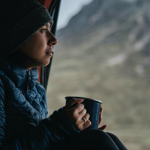Woman in a camper with a cup of coffee - 1077832