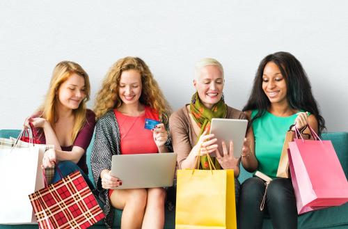 Women on digital devices with their shopping bags - 6577