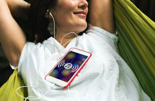 Adult Woman Listening Music With Mobile Phone on Hammock - 6060