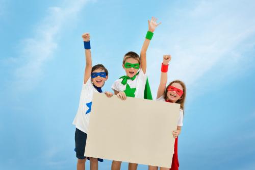 Smiling superhero kids holding an empty placard - 5286