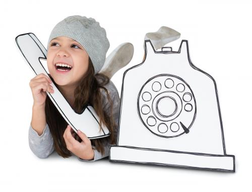Little girl playing pretend with a paper phone - 4427