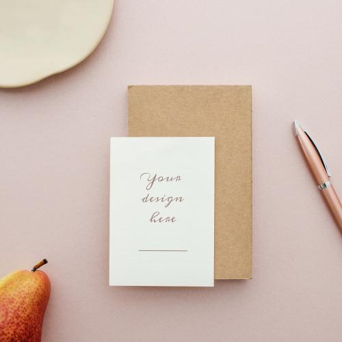 White card mockup on a pastel pink table - 1215172