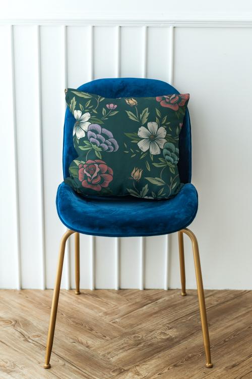 Botanical pattern cushion on a blue velvet chair - 1215181