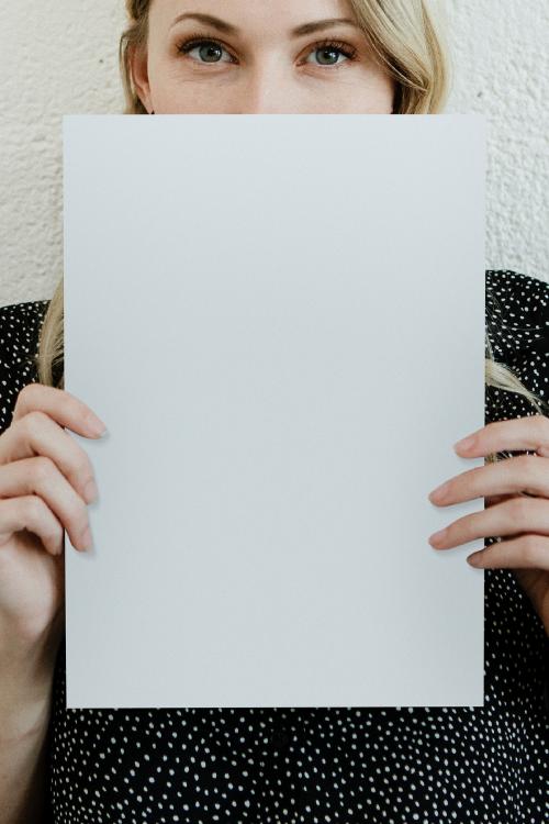 Blond woman showing a blank white poster mockup - 1208393