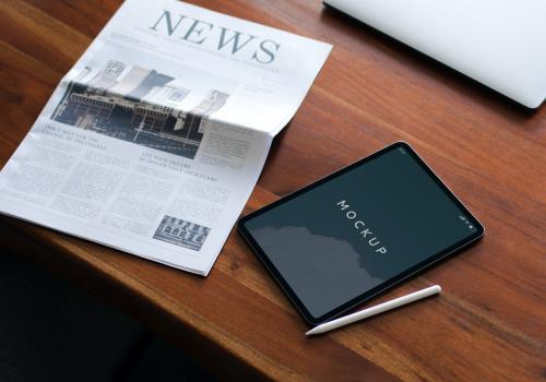 Newspaper on a table with a digital tablet mockup - 1208616