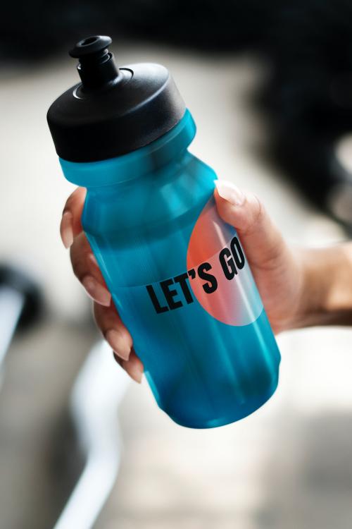 Hand holding a blue water bottle mockup - 2114603