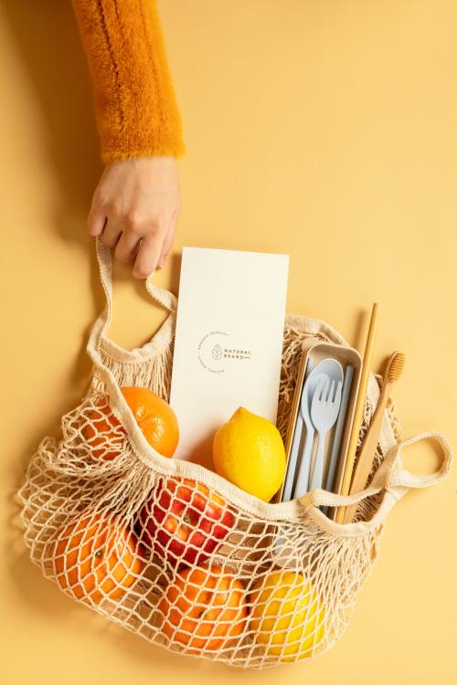 Reusable net bag full with fruits and eco-friendly travel utensils - 2276538