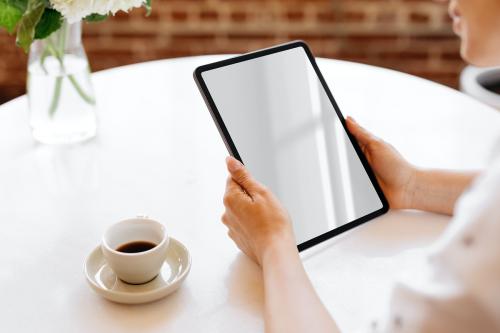 Woman using a digital tablet in a cafe mockup - 2030282
