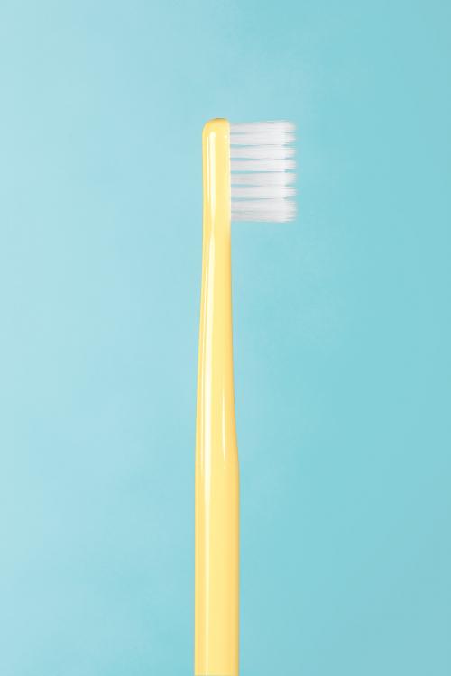 Yellow toothbrush on a blue background - 2053021