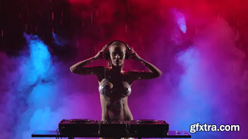 Videohive Hot Dj Woman Playing Music and Dancing in a Dark Studio with Colorful Smoke Illuminated By Neon 28747737