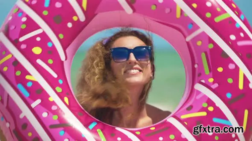 Videohive Beautiful Girl with Inflatable Donut Dancing Against the Sea 24001076