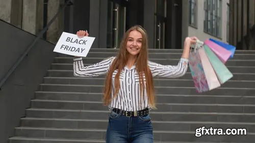 Videohive Joyful Teen Girl Showing Black Friday Inscription, Smiling, Looking Satisfied with Low Prices 28773801