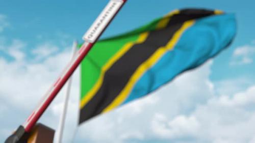 Videohive - Closing Barrier with QUARANTINE Sign at the Tanzanian Flag - 32341104