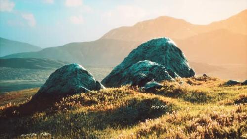 Videohive - Meadow with Huge Stones Among the Grass on the Hillside at Sunset - 32496675