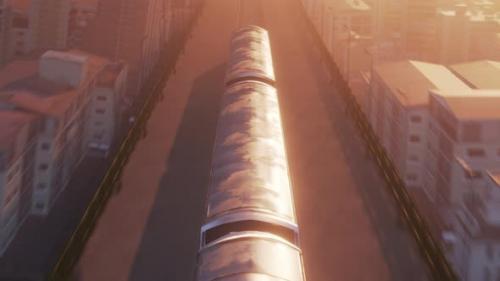 Videohive - Aerial View of Train in Warm Sunset Light Passing Through City - 32581123
