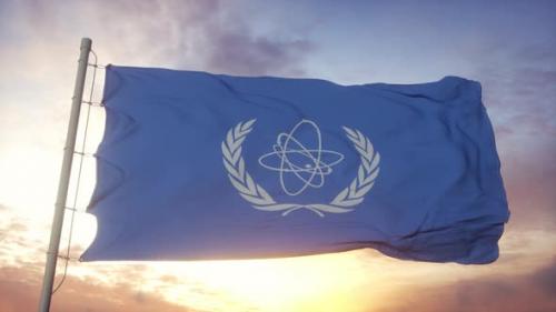 Videohive - Flag of International Atomic Energy Agency IAEA Waving in the Wind Sky and Sun Background - 33592669