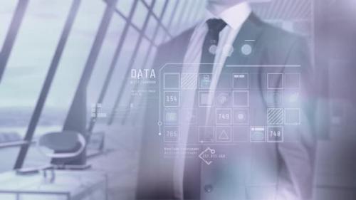 Videohive - Businessman Browses Corporate Data And Modern Office Background 4K - 33620455