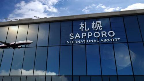 Videohive - Airplane landing at Sapporo Japan airport mirrored in terminal - 33661320