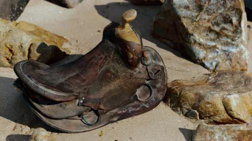 Videohive - Very Old Horse Saddle on Sand Beach - 35252640