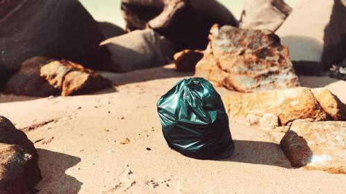 Videohive - Black Plastic Garbage Bag Full of Trash on the Beach - 35324662