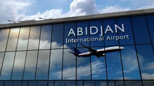 Videohive - Airplane landing at Abidjan Ivory Coast airport mirrored in terminal - 35633649