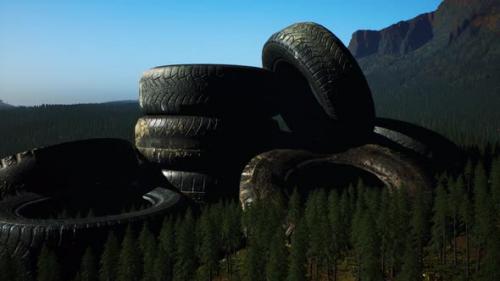 Videohive - Concept of Environmental Pollution with Big Old Tires in Mountain Forest - 37087153