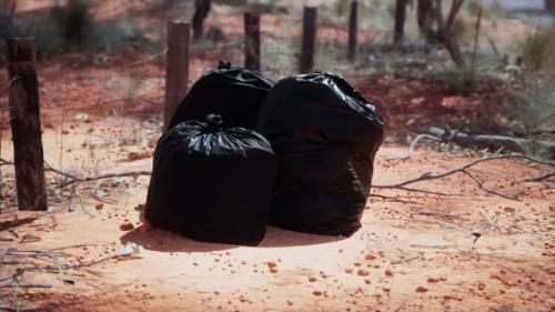 Videohive - Closeup of Full Trash Bags on the Sand - 43426495