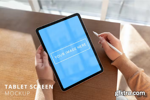 iPad Air Screen Mockup in Woman\'s Hand Over Table