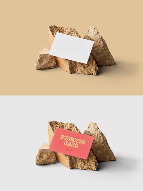 Mockup of customizable horizontal color business card resting against rocks available against customizable color background 582961060
