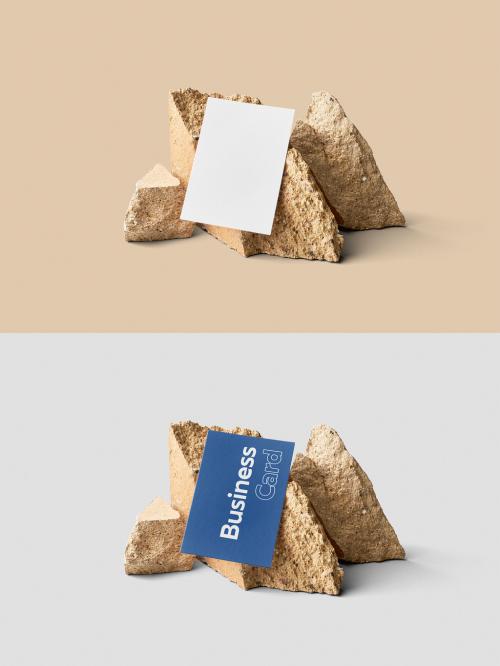 Mockup of customizable vertical color business card resting against rocks available against customizable color background 582961106