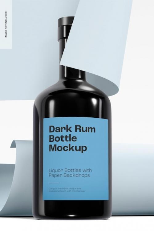 Premium PSD | Dark rum bottle with paper backdrop mockup Premium PSD
