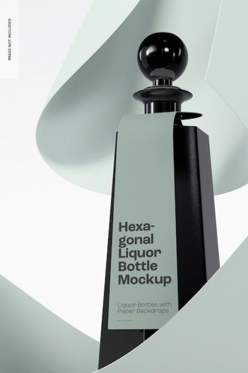 Premium PSD | Hexagonal liquor bottle with paper backdrop mockup, close up Premium PSD