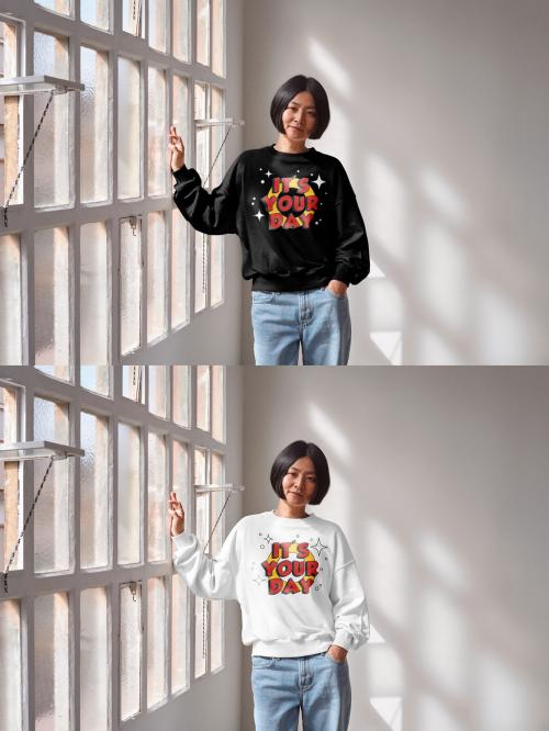 Mockup of Asian woman wearing sweatshirt with customizable color leaning on window 640128123