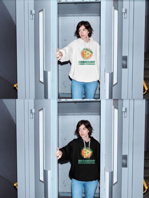 Mockup of woman wearing hoodie with customizable color in doorway, camera flash 649149609