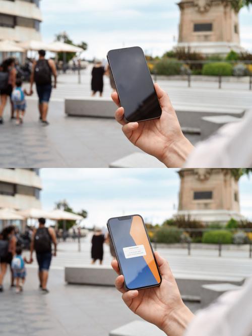 Mockup of person using smartphone with customizable screen in city scene 649151371