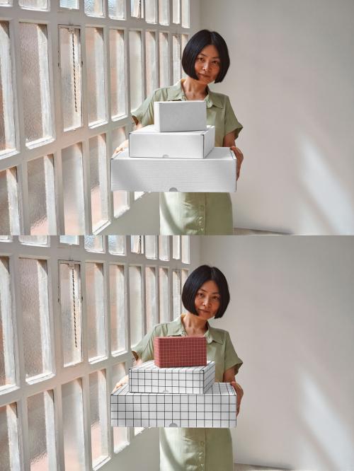 Mockup of Asian woman holding customizable gift boxes stacked up 646709672