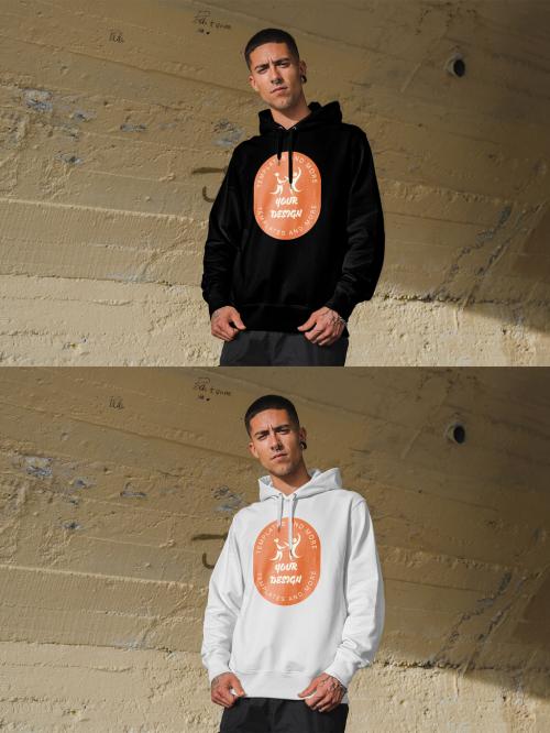 Mockup of man wearing hoodie with customizable color by concrete wall 644105270