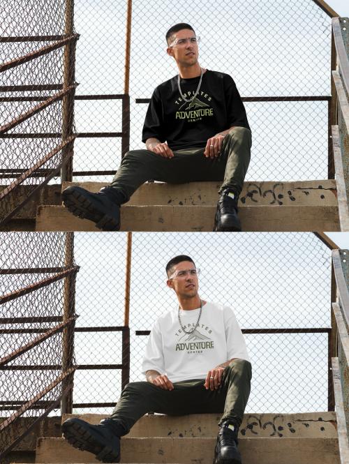 Mockup of man wearing t-shirt with customizable color sitting on steps 644103827