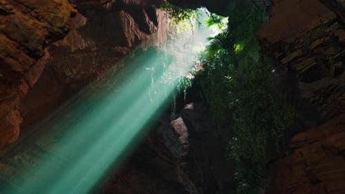 Videohive - A Mesmerizing Green Light Shining Through the Entrance of a Mystical Cave - 48388532
