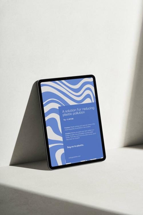 Smart Tablet on a Grey Surface with Hard Light Mockup